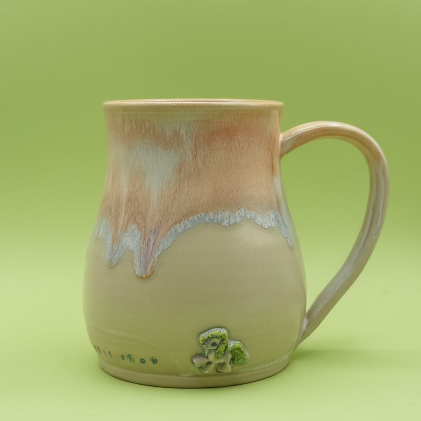Ceramic mug with a decorative design on a green background