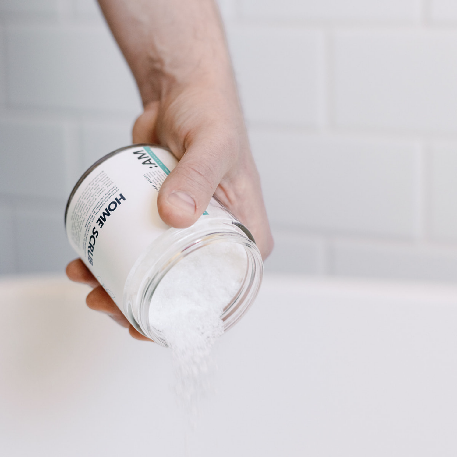 Pouring Home Scrub Cleaner powder from jar