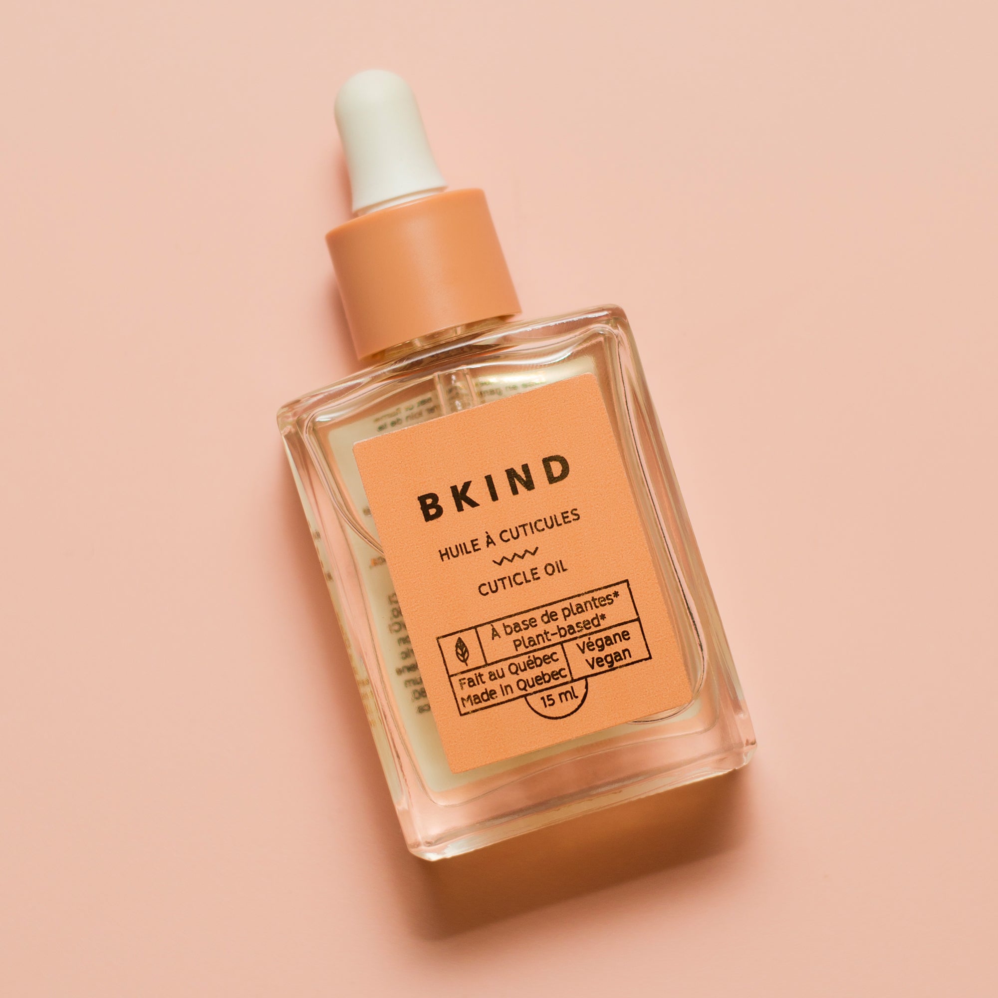 Close-up of BKIND cuticle oil bottle – Calgary vegan nail care for soft cuticles and plant-based beauty.