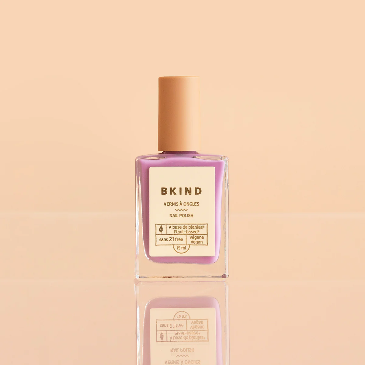 BKIND Floatie nail polish bottle on peach background
