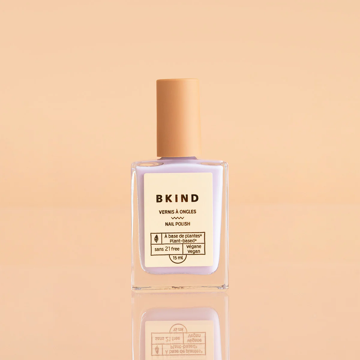BKIND Kikini nail polish bottle on peach background