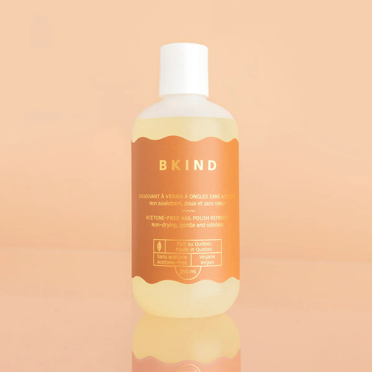 BKIND Acetone-Free Nail Polish Remover standing on peach background