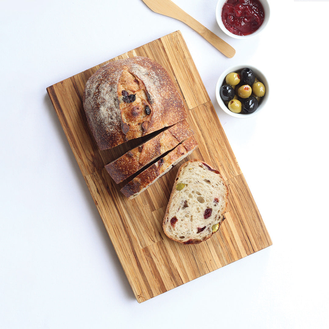 Brotzeit Butcher Block serving board with sliced sourdough and olives at Greenbriar Market Calgary