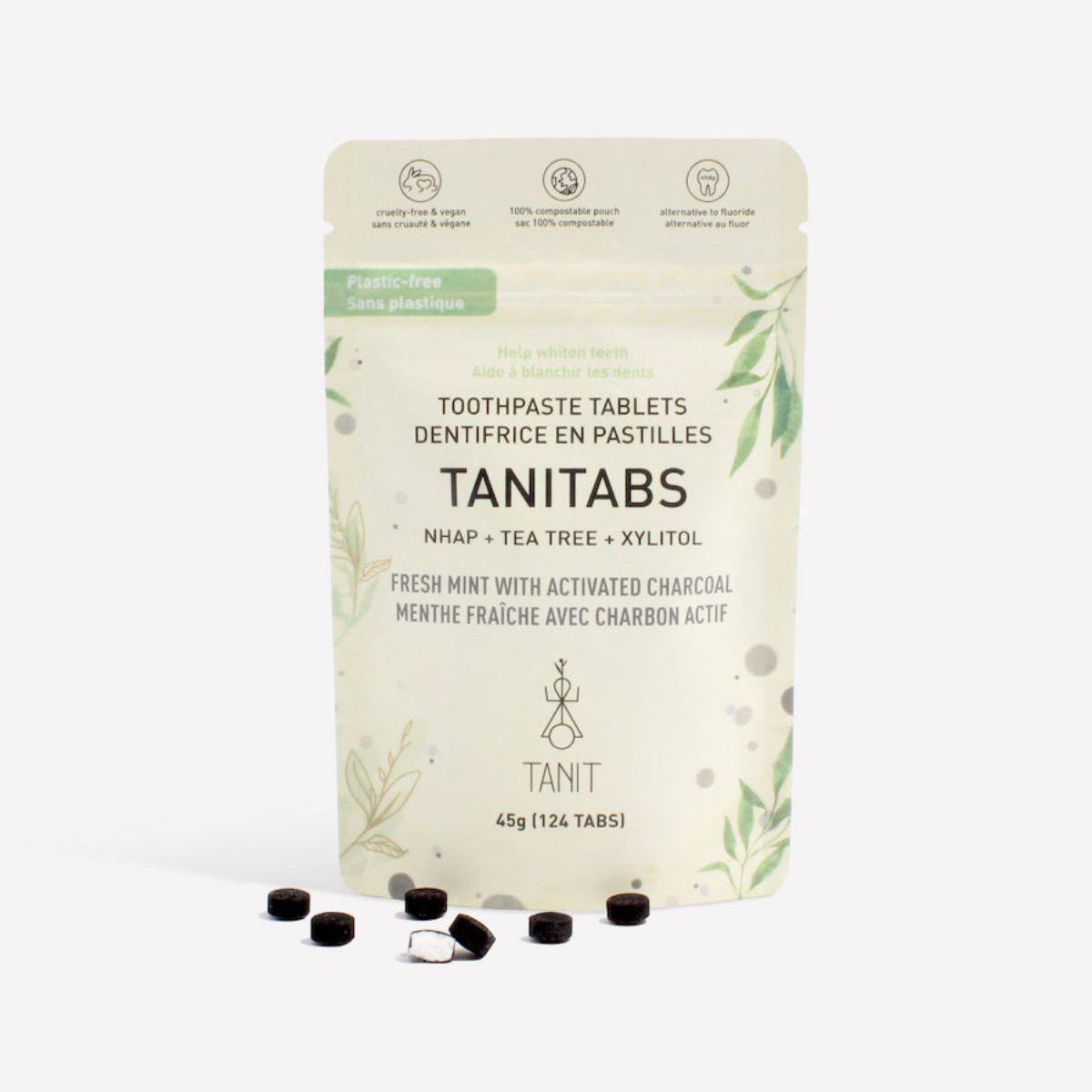 Tanitabs Charcoal Mint toothpaste tabs in compostable pouch with scattered tablets – Calgary sustainable oral care product
