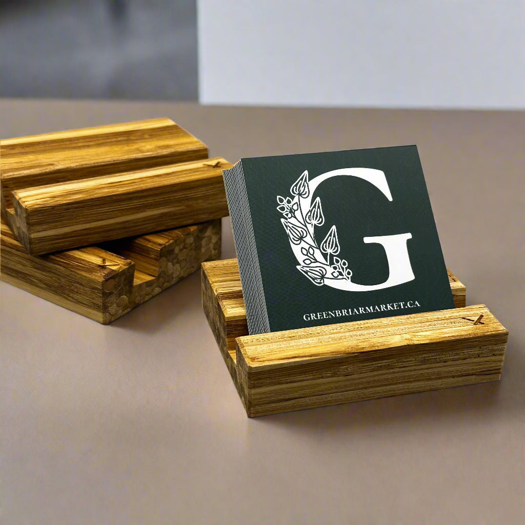 Sustainable business card holder made in Calgary from recycled chopsticks, shown holding a Greenbriar Market card.