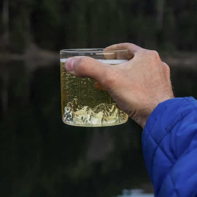 Bugaboos tumbler glass by MTNPK held outdoors with sparkling drink, available at Greenbriar Market in Calgary