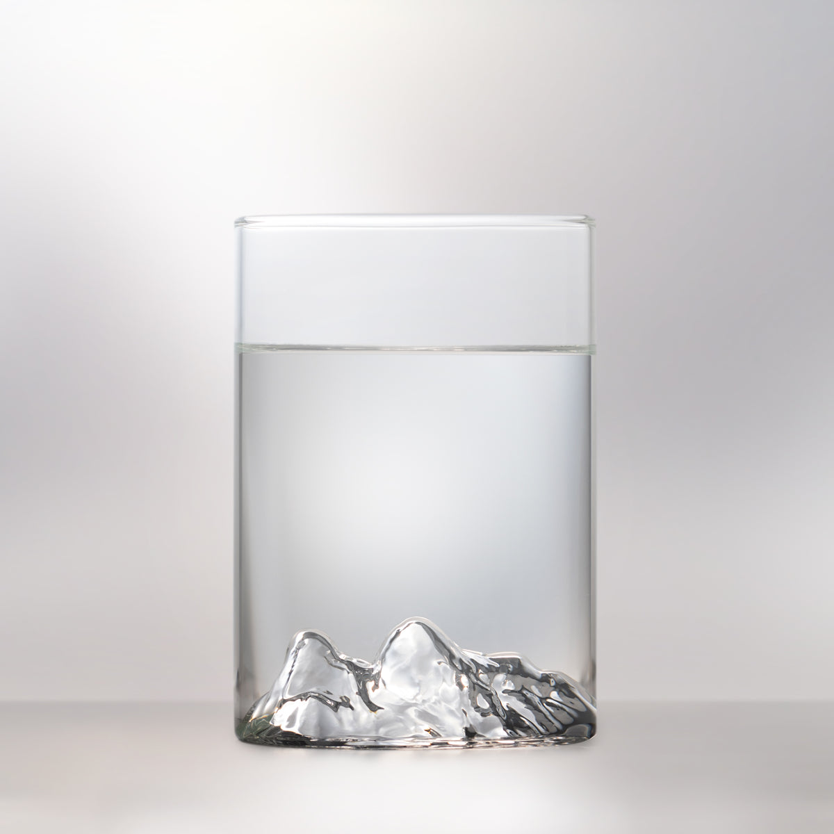 Front view of Two Lions pint glass by MTNPK with clear liquid, available at Greenbriar Market in Calgary