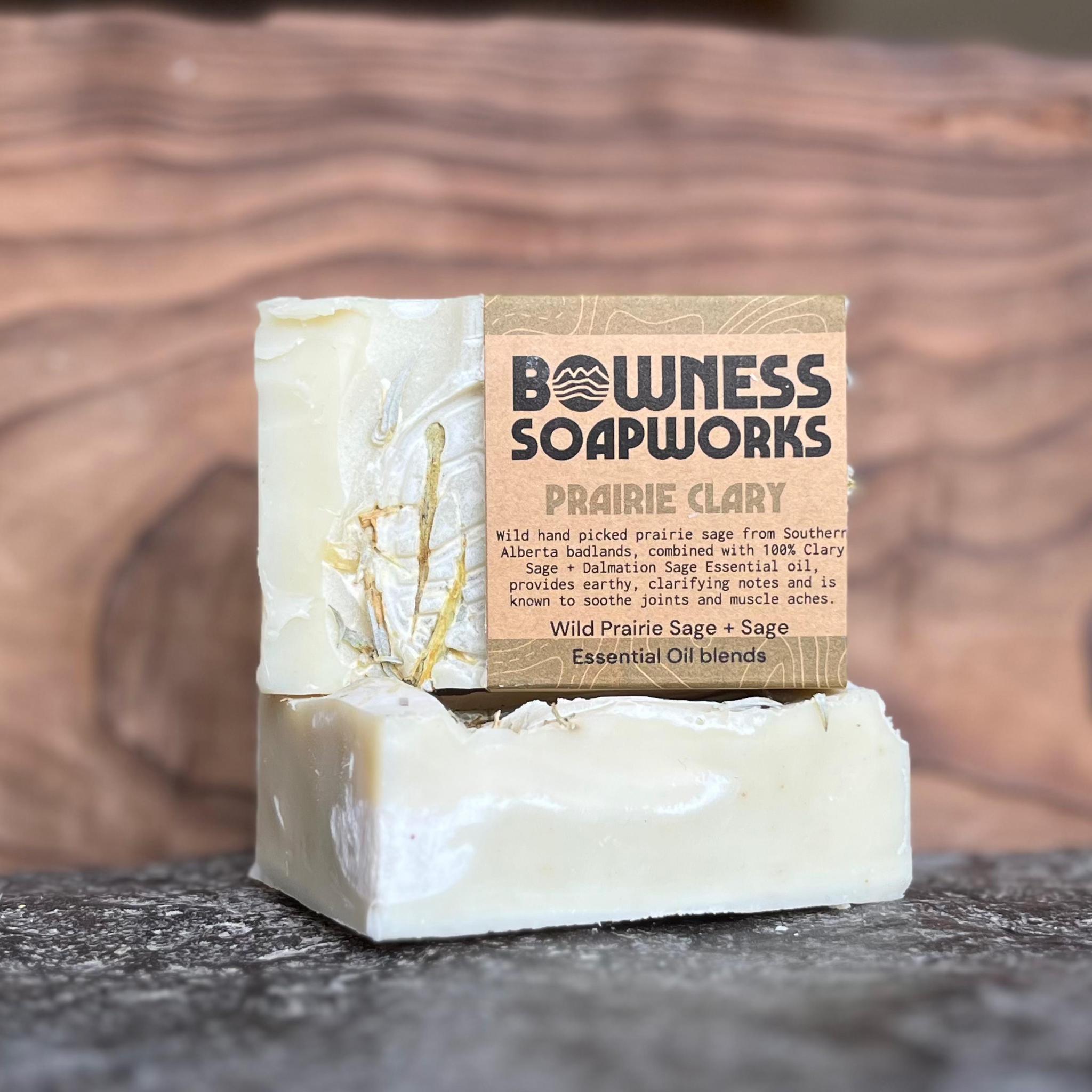 Handmade sage and clary sage soap bar made in Calgary by Bowness Soapworks, shown with dried botanicals on stone and wood