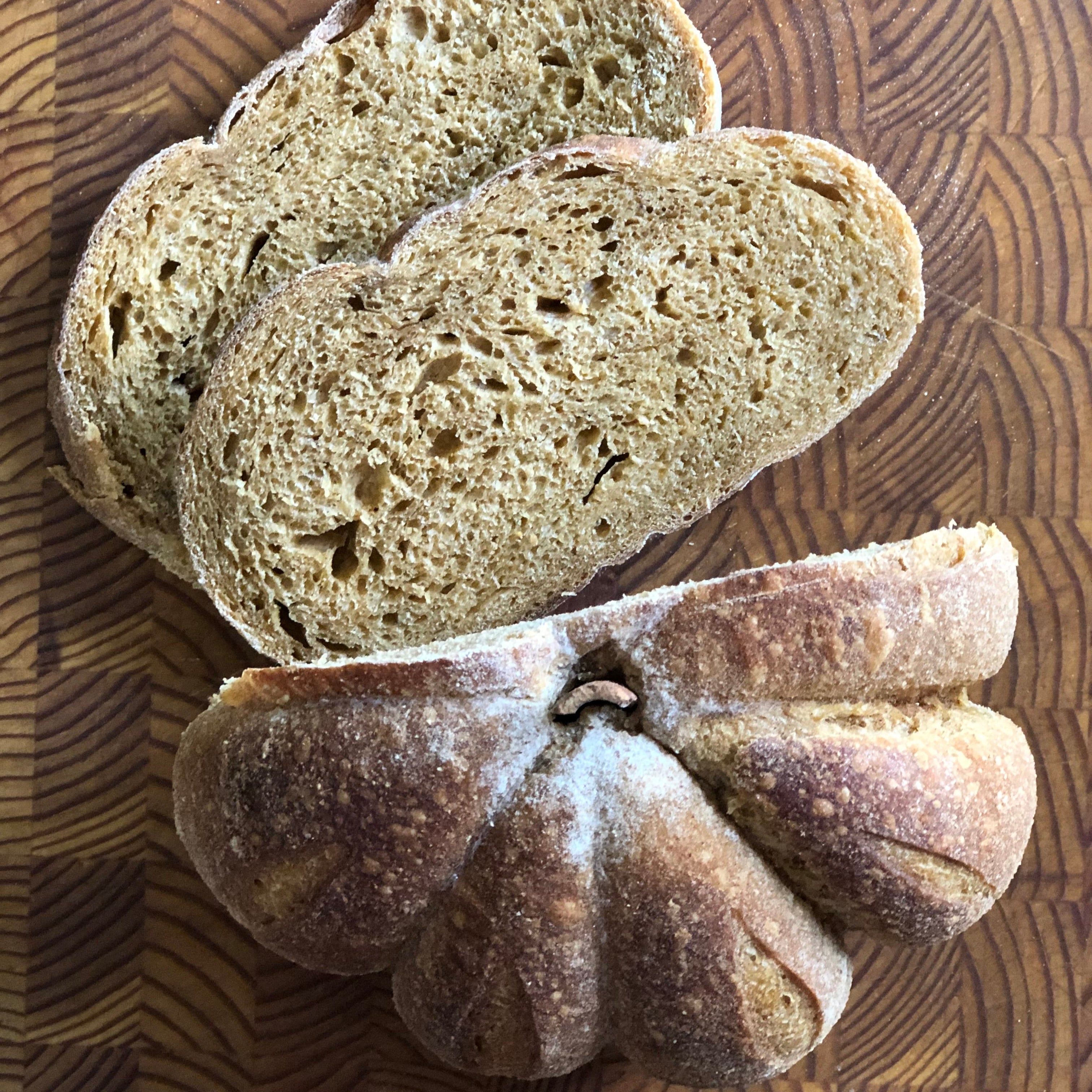 Fresh pumpkin spice sourdough sliced on a cutting board from a Calgary bakery