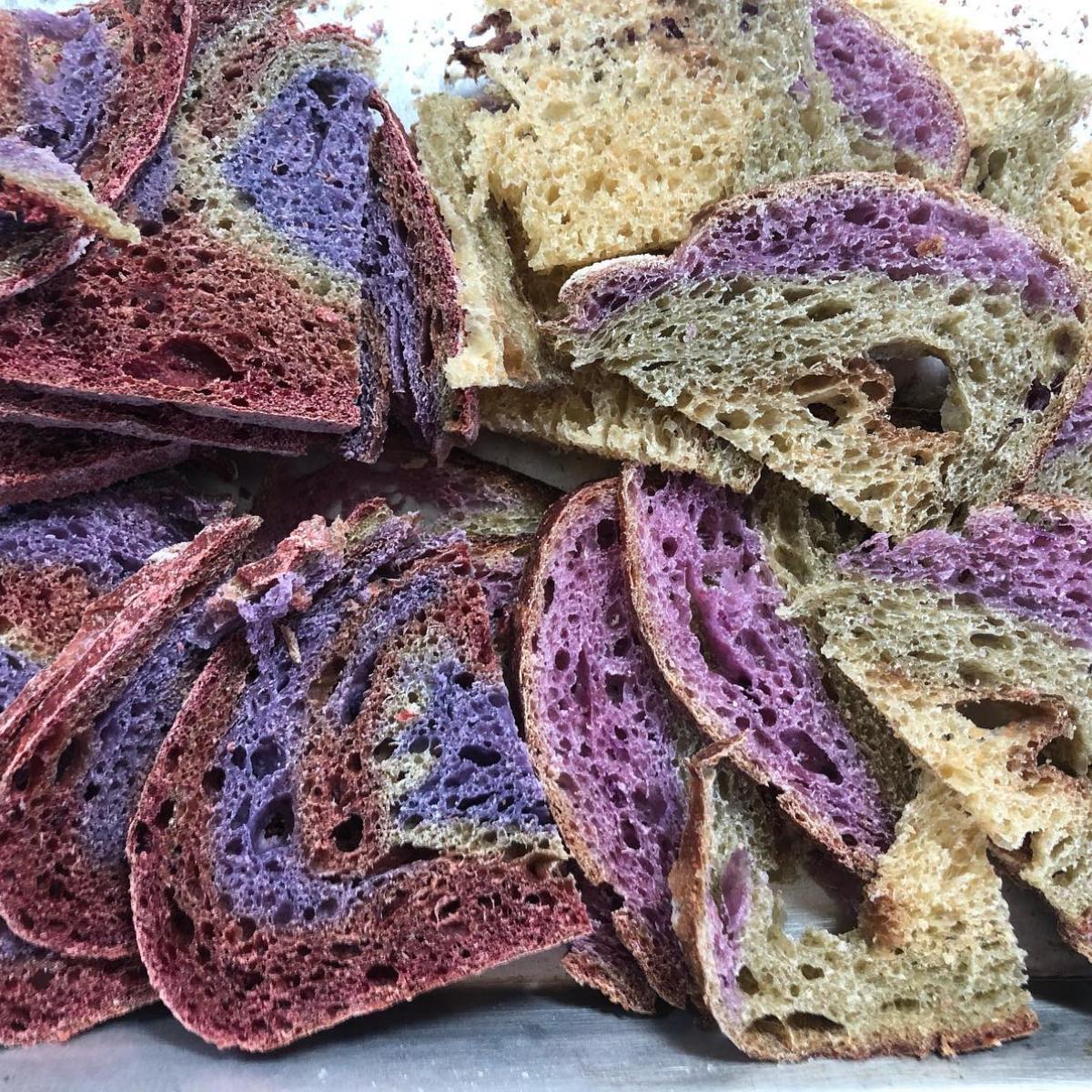 Slices of Rainbow Sourdough with colourful veggie swirls, baked in Calgary by Homestead Bread for Greenbriar Market pre-orders