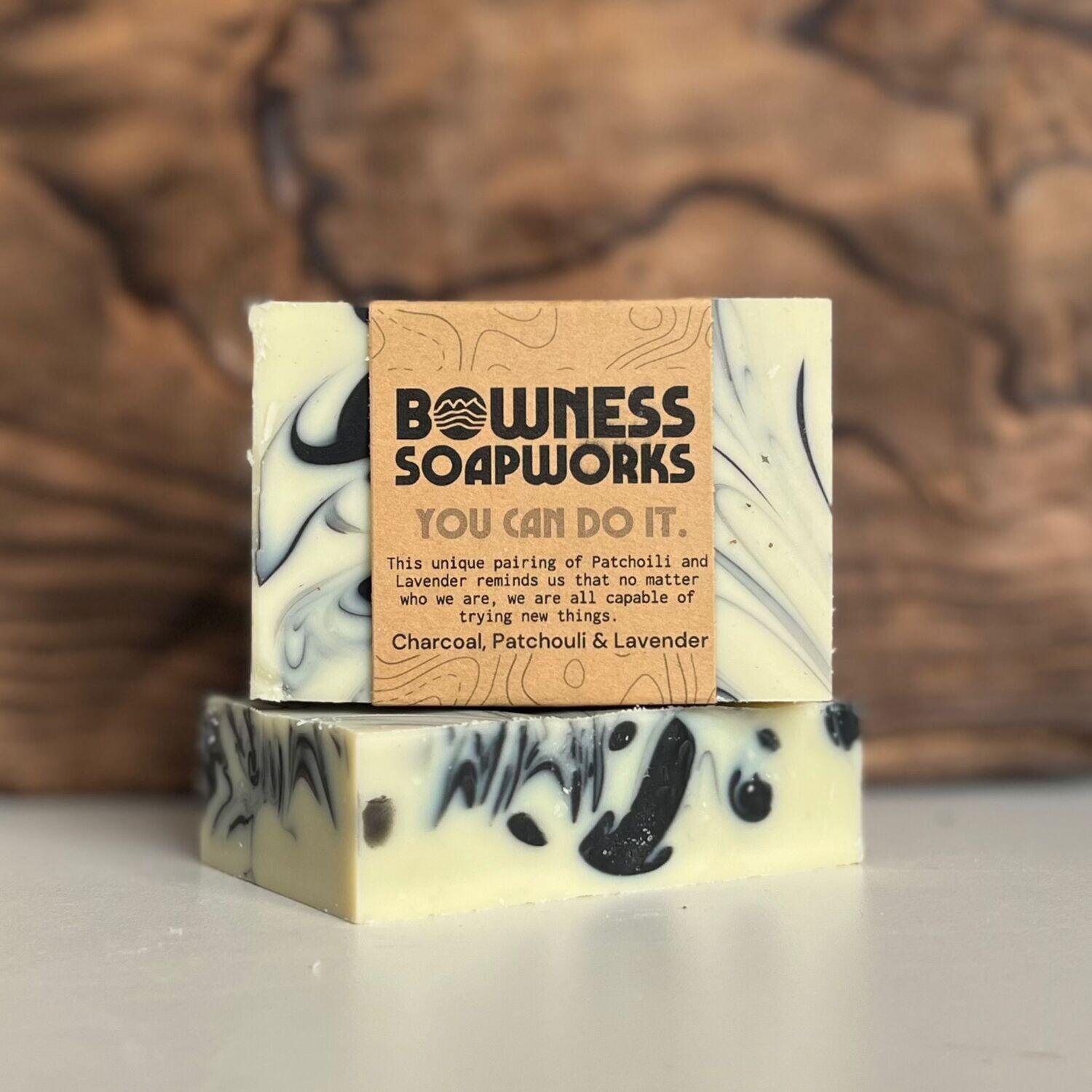Herbal soap with patchouli, lavender, and charcoal by Bowness Soapworks in Calgary, shown stacked with swirl detailing and kraft label