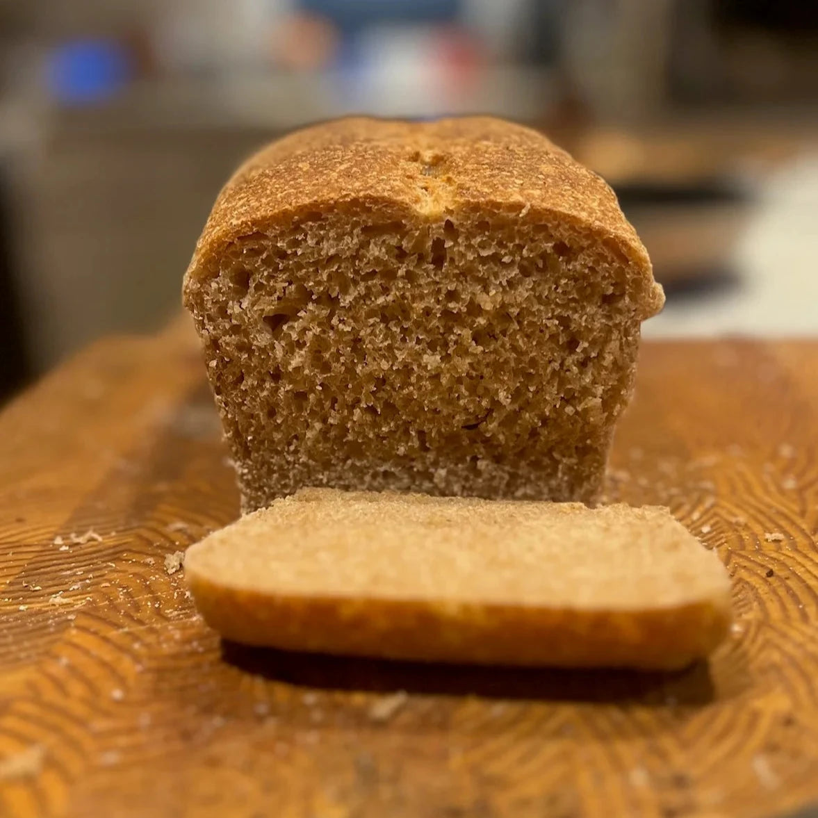 50% wholegrain sourdough sandwich loaf sliced on a wooden cutting board in Calgary