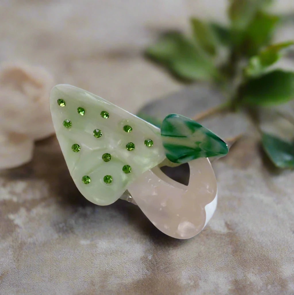Green mushroom hair clip with gem accents, Calgary hair accessory styled for woodland-inspired fashion looks.