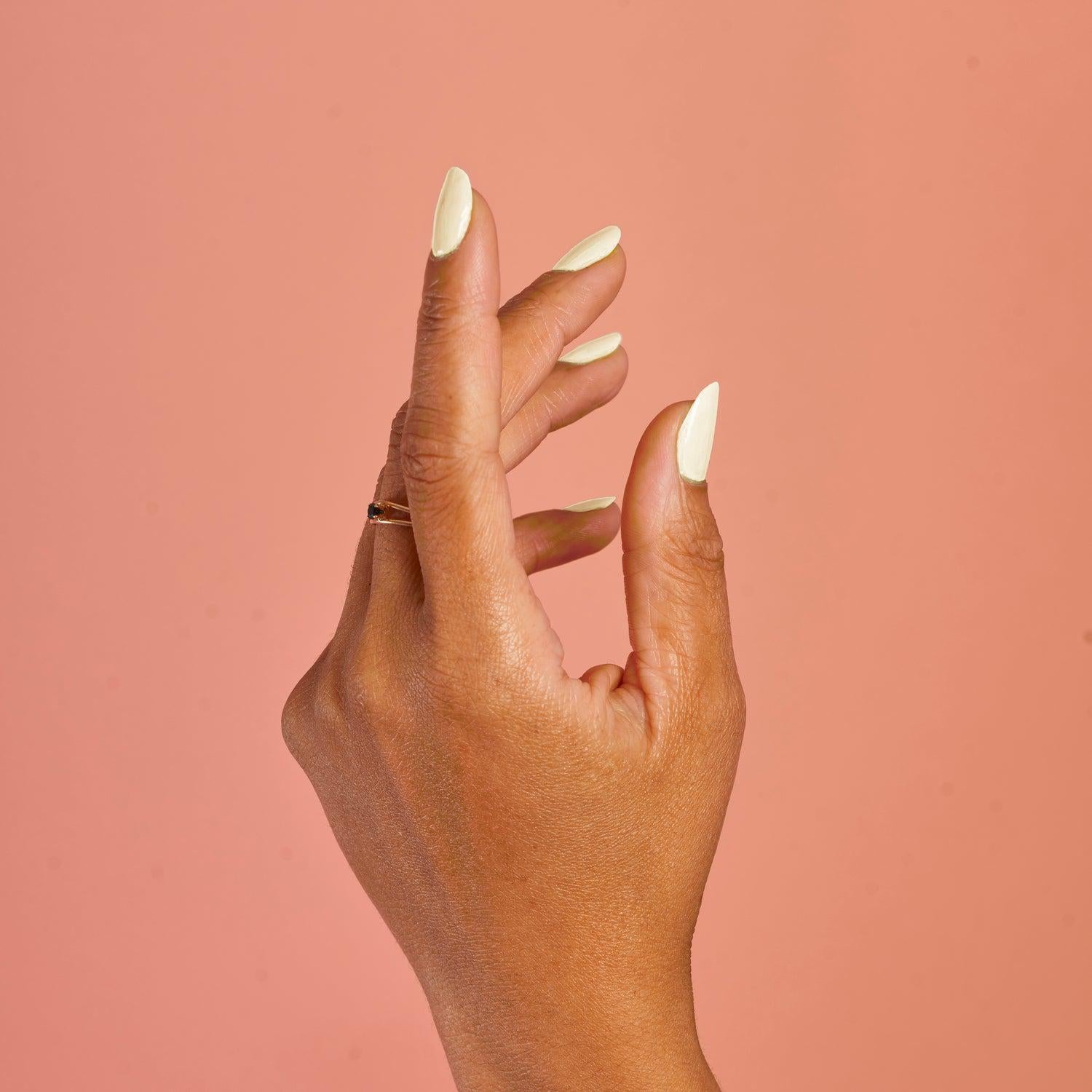 Hand with BKIND Bichon nail polish – Calgary non-toxic white manicure with a matte vegan finish.