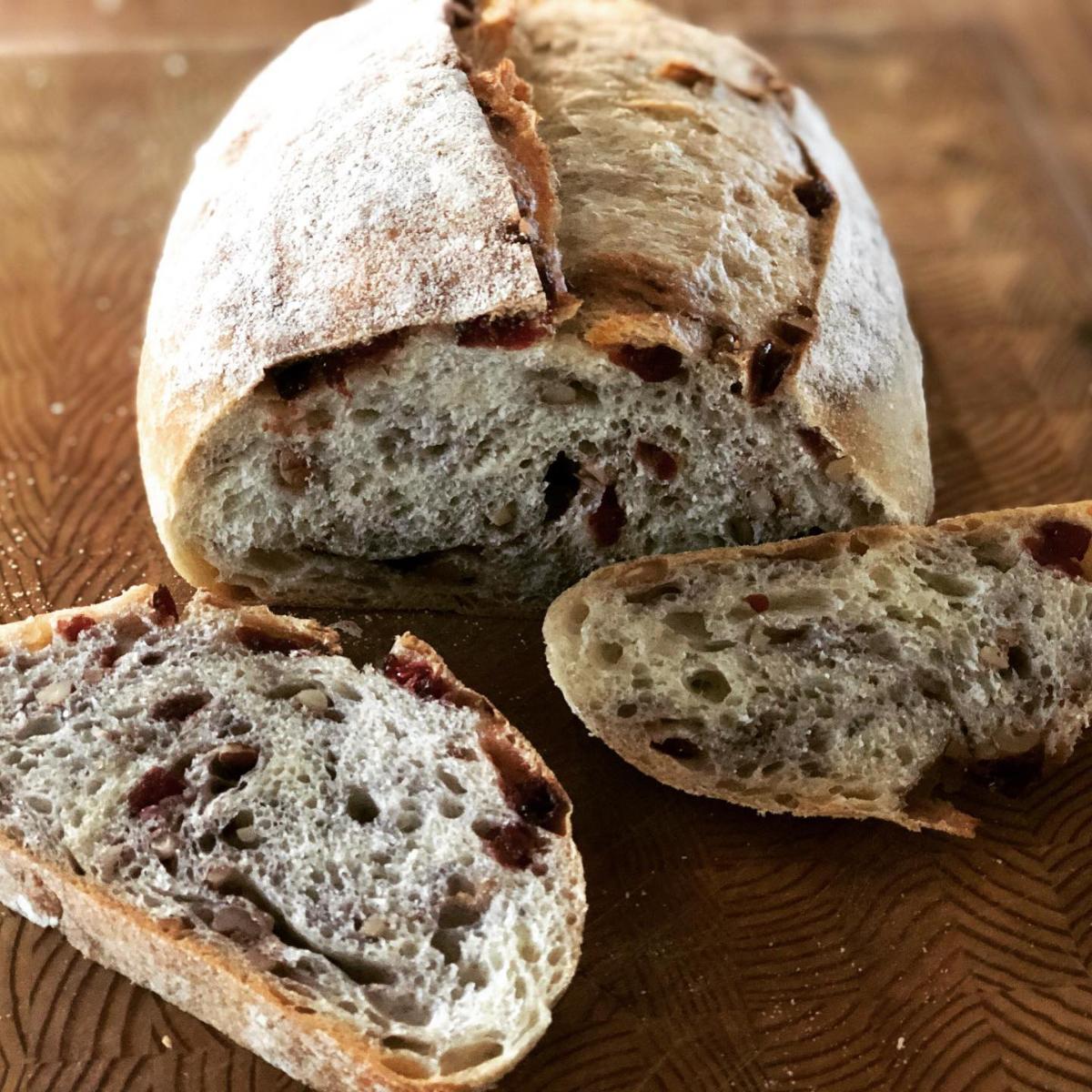 Cranberry walnut sourdough loaf with pink-hued crumb from Homestead Bread in Calgary, available Fridays at Greenbriar Market