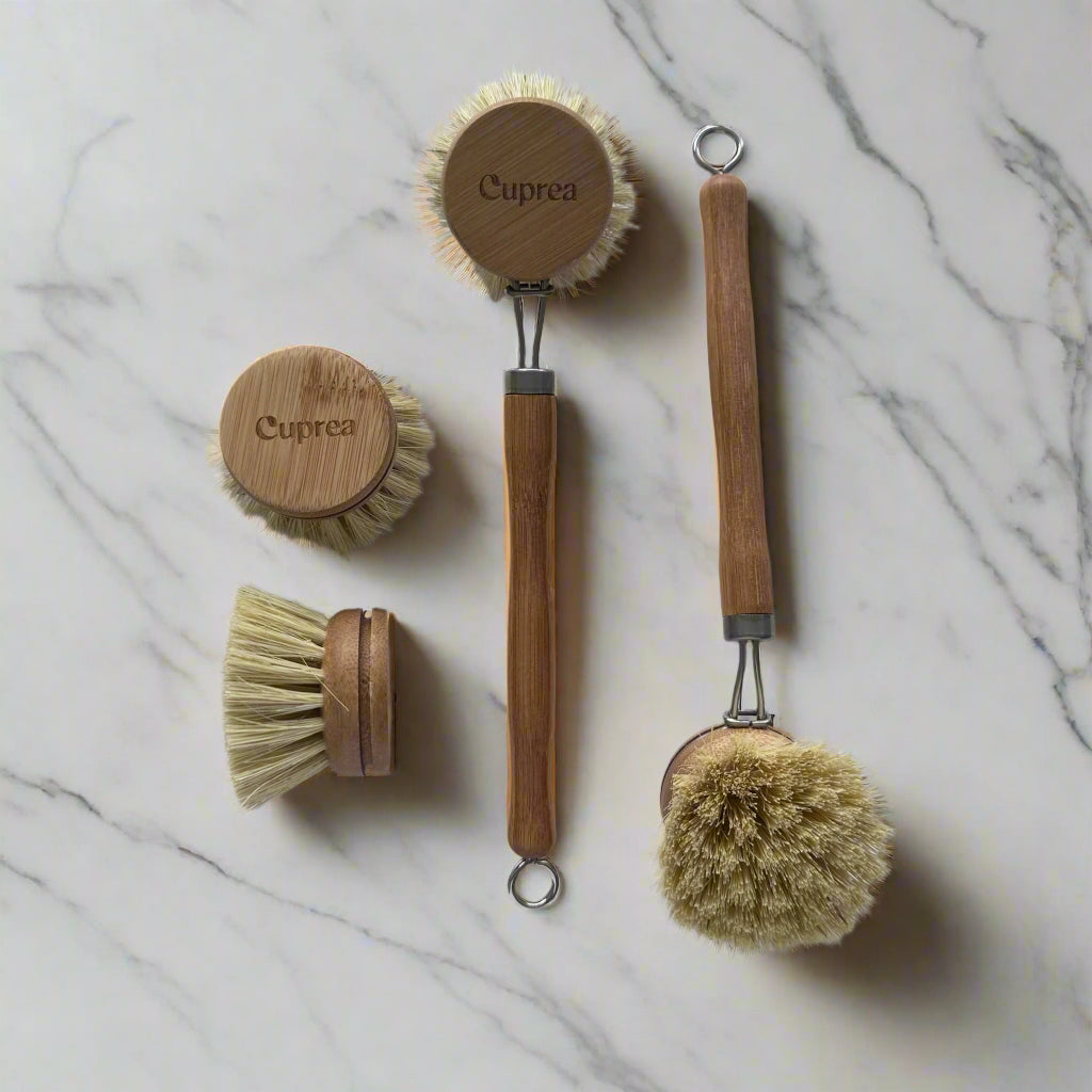Cuprea bamboo dish brush with natural bristles and replacement heads on white marble kitchen counter – plastic-free cleaning brush in Calgary