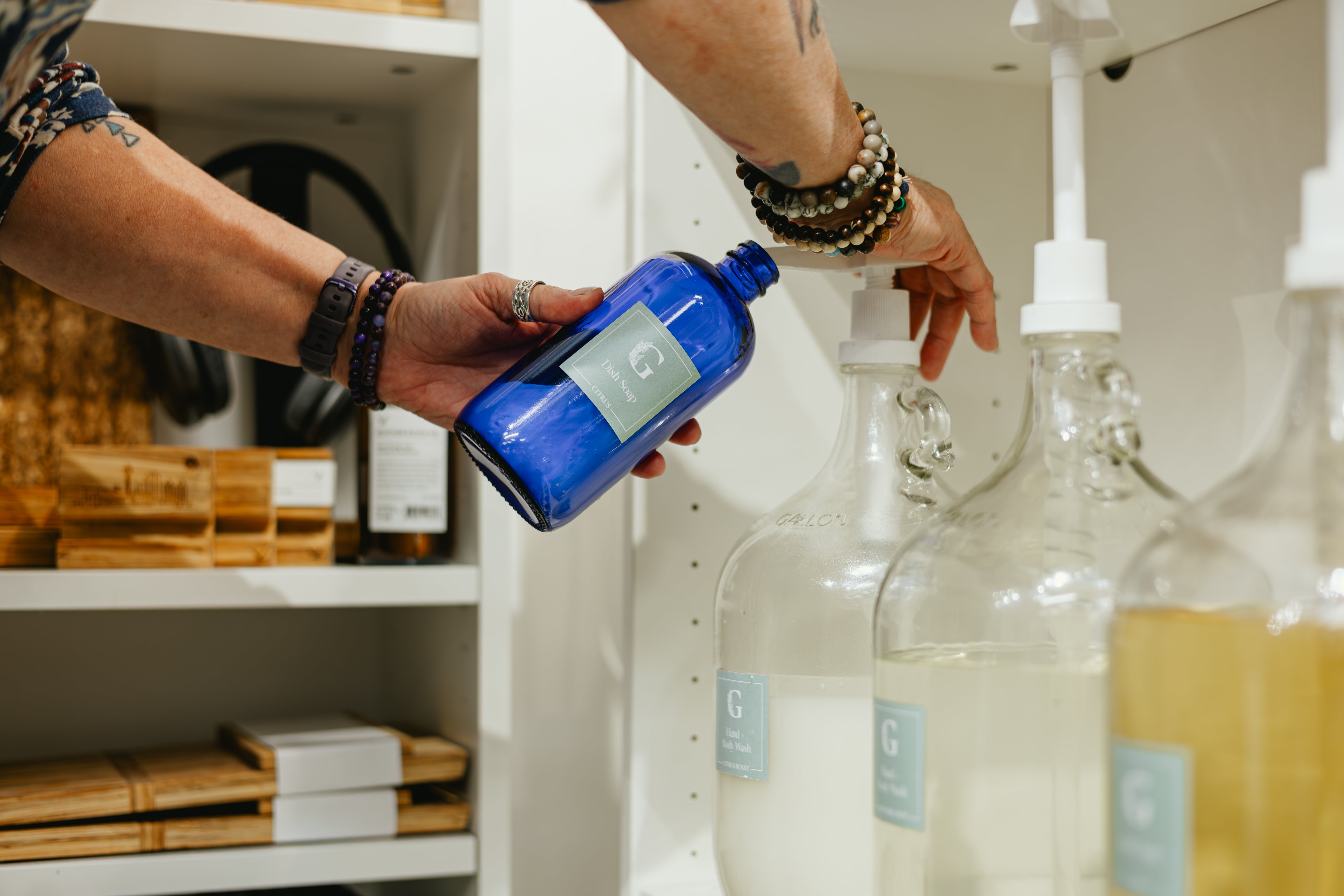 Refilling a reusable bottle at the Greenbriar Market refill bar at Crossroads Market in Calgary
