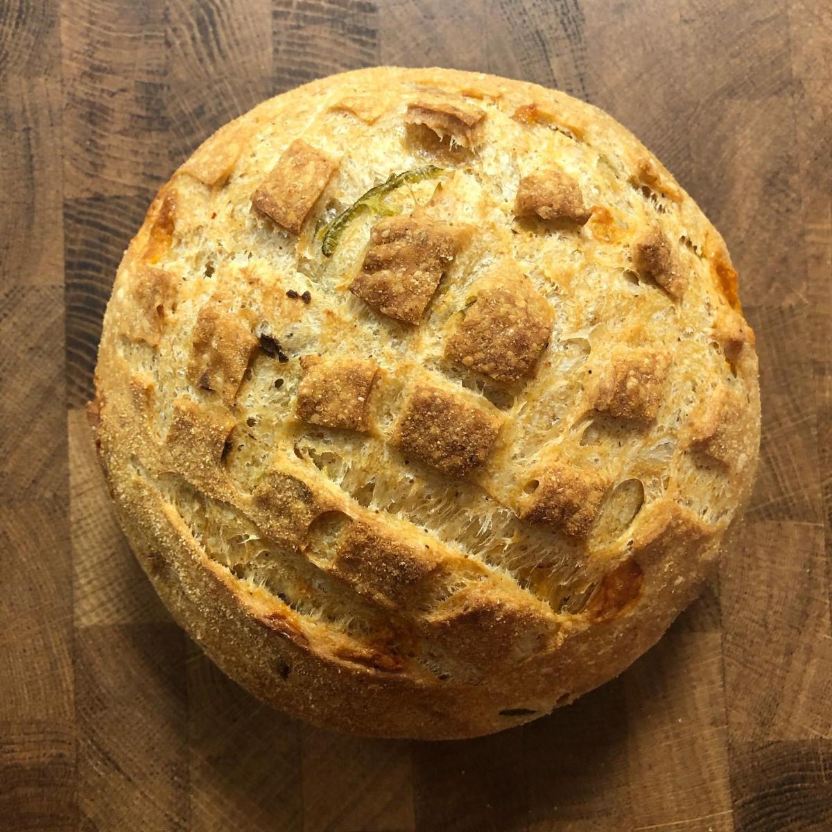 Jalapeño cheddar sourdough loaf with fresh peppers and aged cheese, baked by Homestead Bread in Calgary for Greenbriar Market pickup