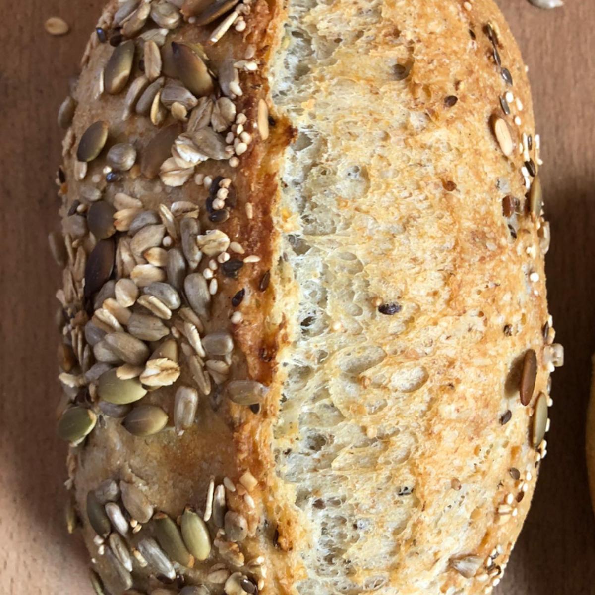 Seeded sourdough loaf from Homestead Bread in Calgary, with flax and sunflower seeds, available weekly at Greenbriar Market