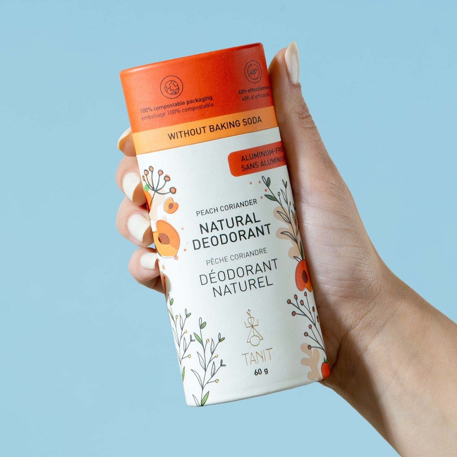 Tanit aluminum-free baking soda-free natural deodorant in Peach Coriander scent held in hand